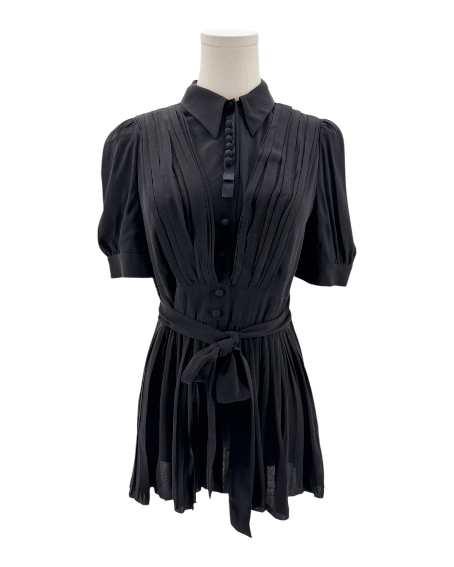 Black dress on a mannequin against a white background