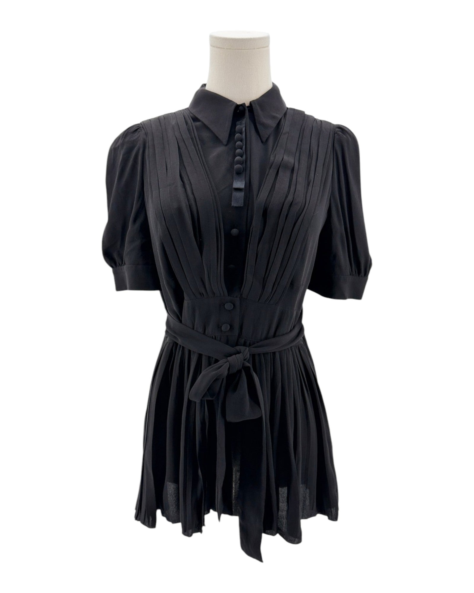 Black dress on a mannequin against a white background