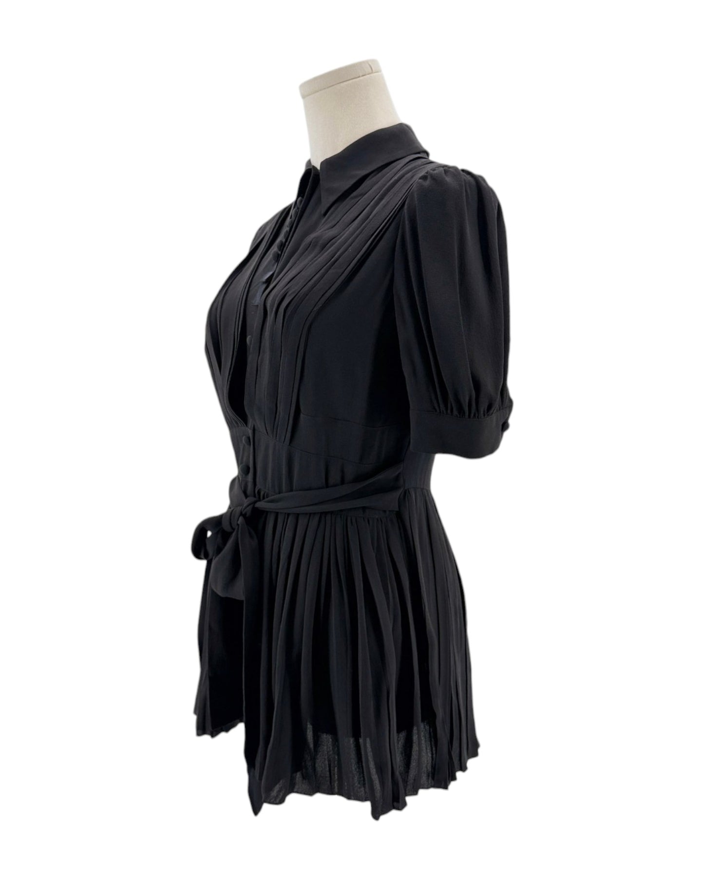 Black dress on a mannequin against a white background