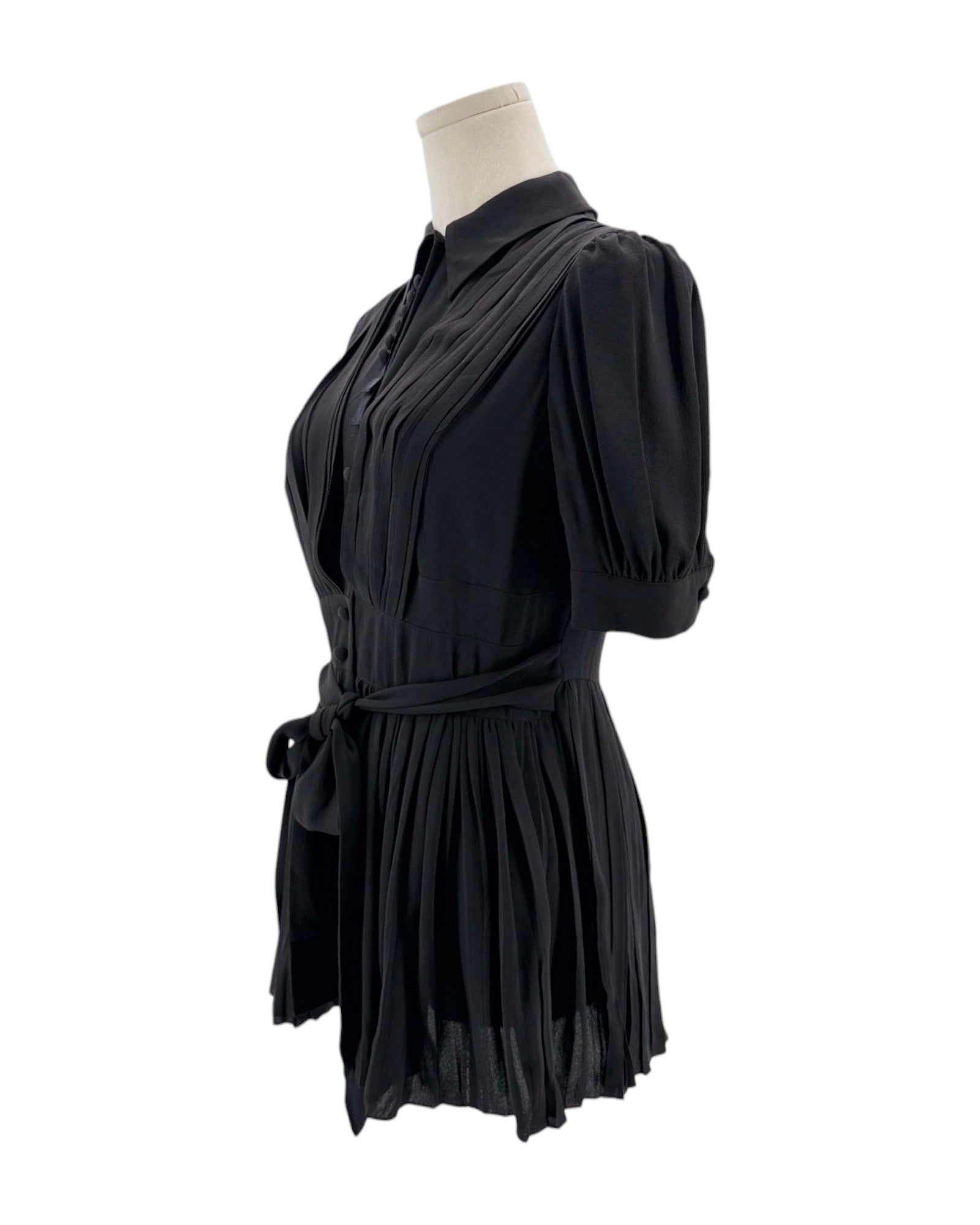 Black dress on a mannequin against a white background