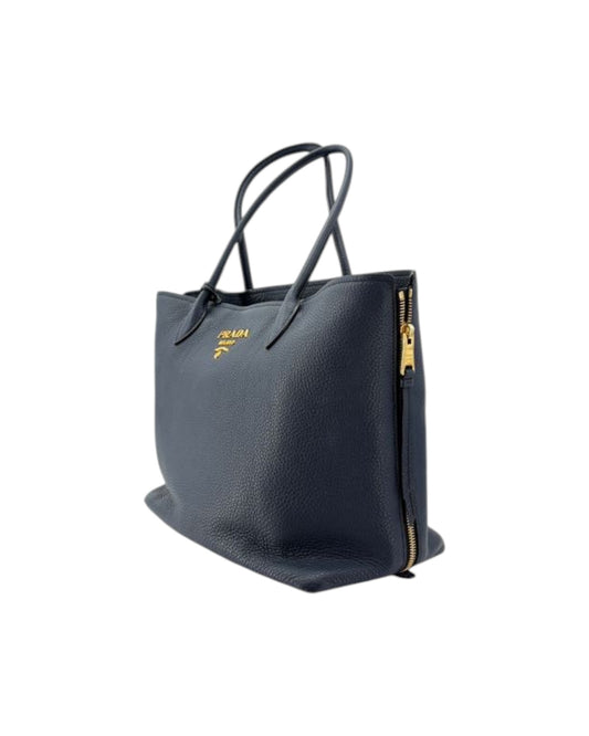 Navy handbag with gold accents on a white background