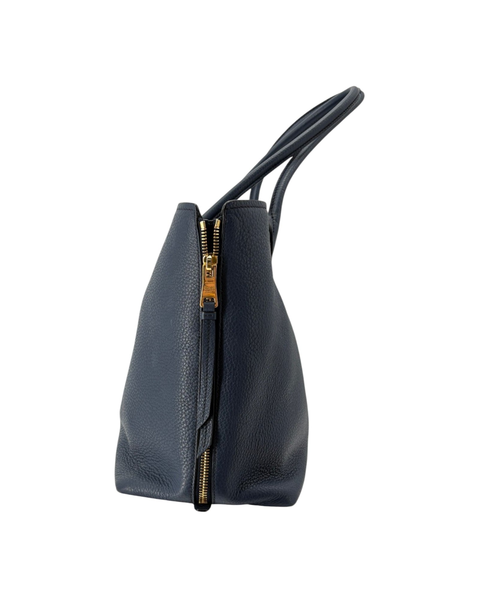 Navy leather handbag with a gold zipper on a white background