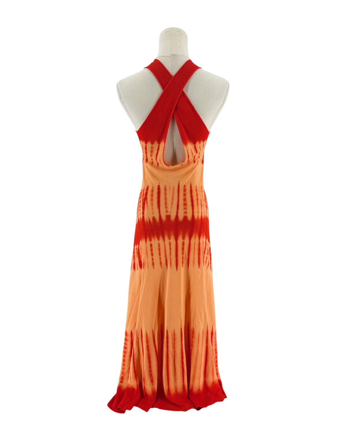 A sleeveless red and orange maxi dress with a tie-dye pattern fading into orange on a white mannequin torso against a white background.