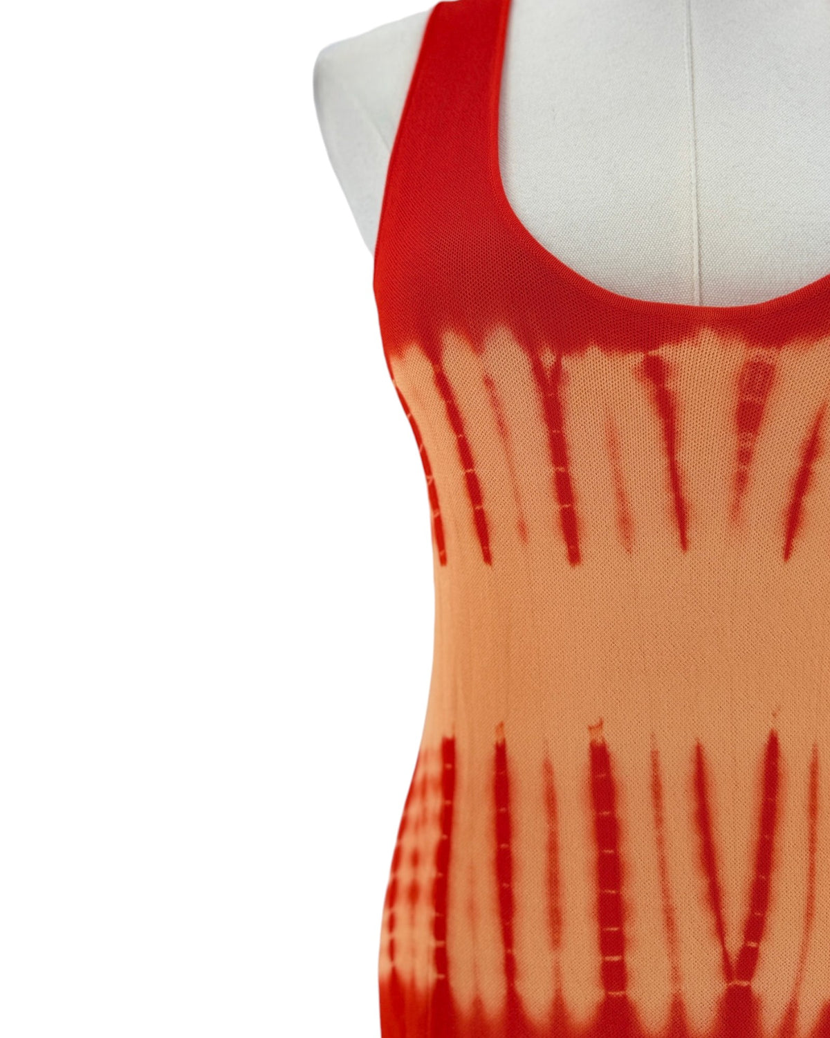 A sleeveless red and orange maxi dress with a tie-dye pattern fading into orange on a white mannequin torso against a white background.