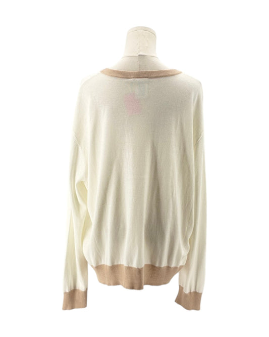 White sweater with brown trim on a mannequin against a white background