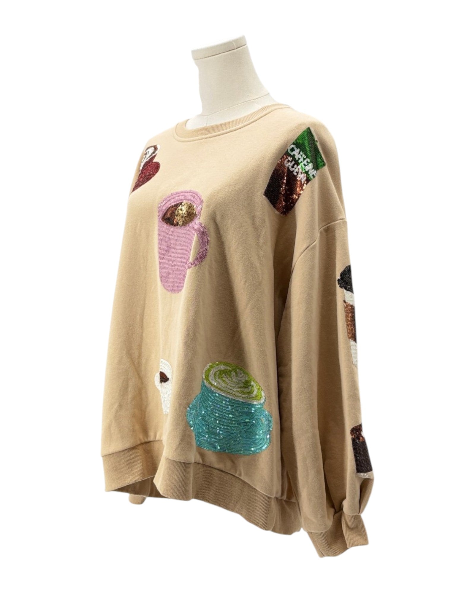 Beige sweatshirt with colorful patches on a mannequin against a white background