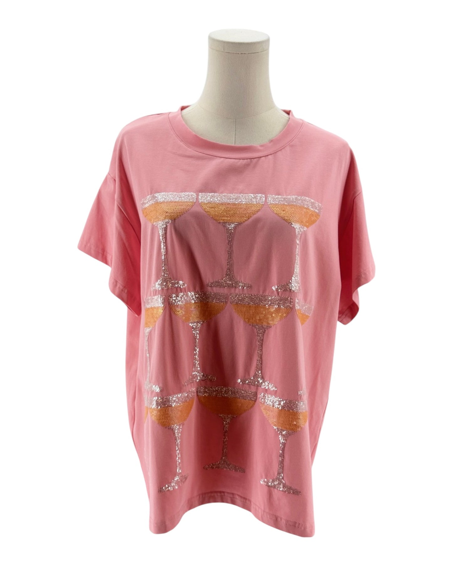 Pink t-shirt with glass design on a mannequin against a white background