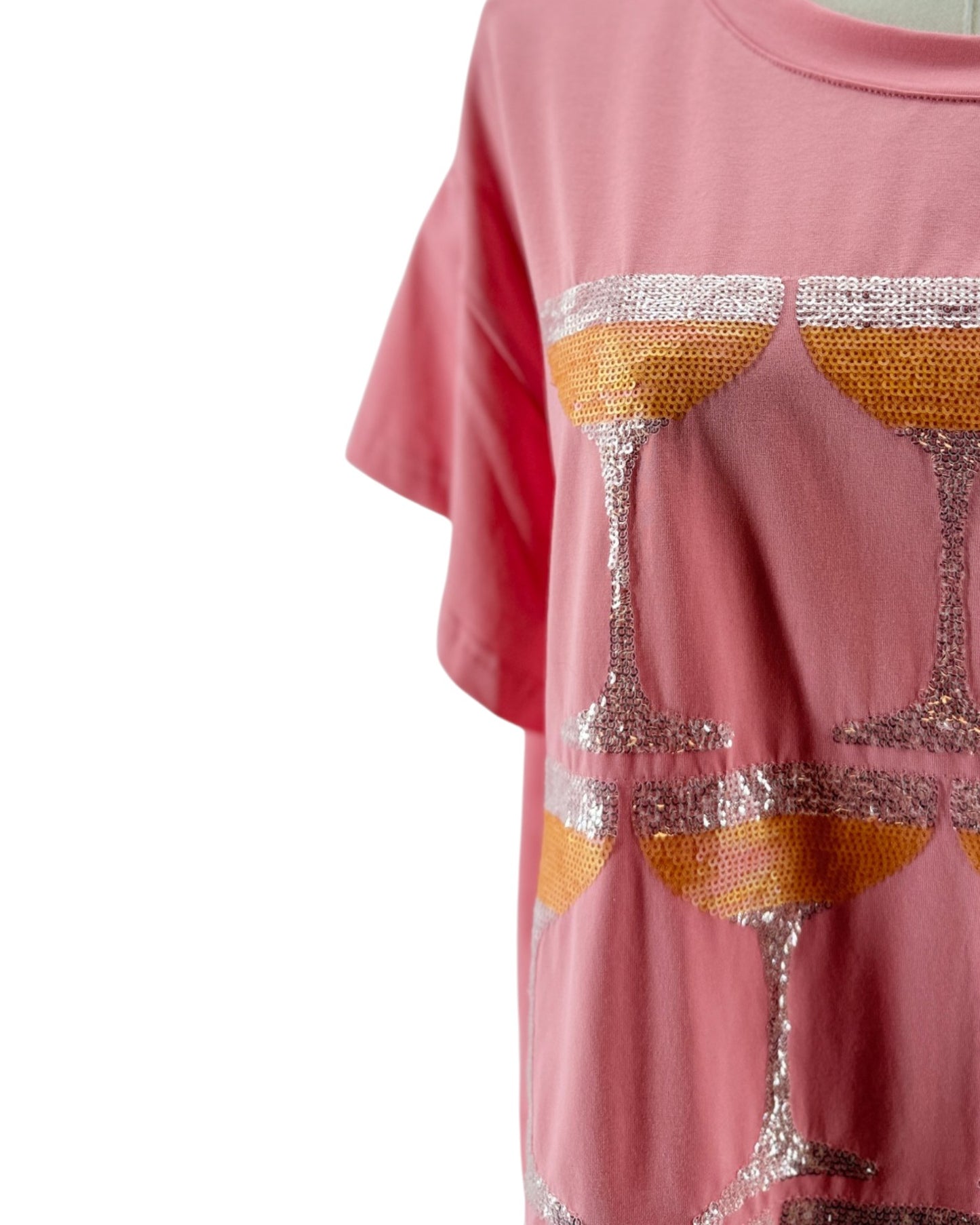 Pink t-shirt with sequin wine glass design on a white background