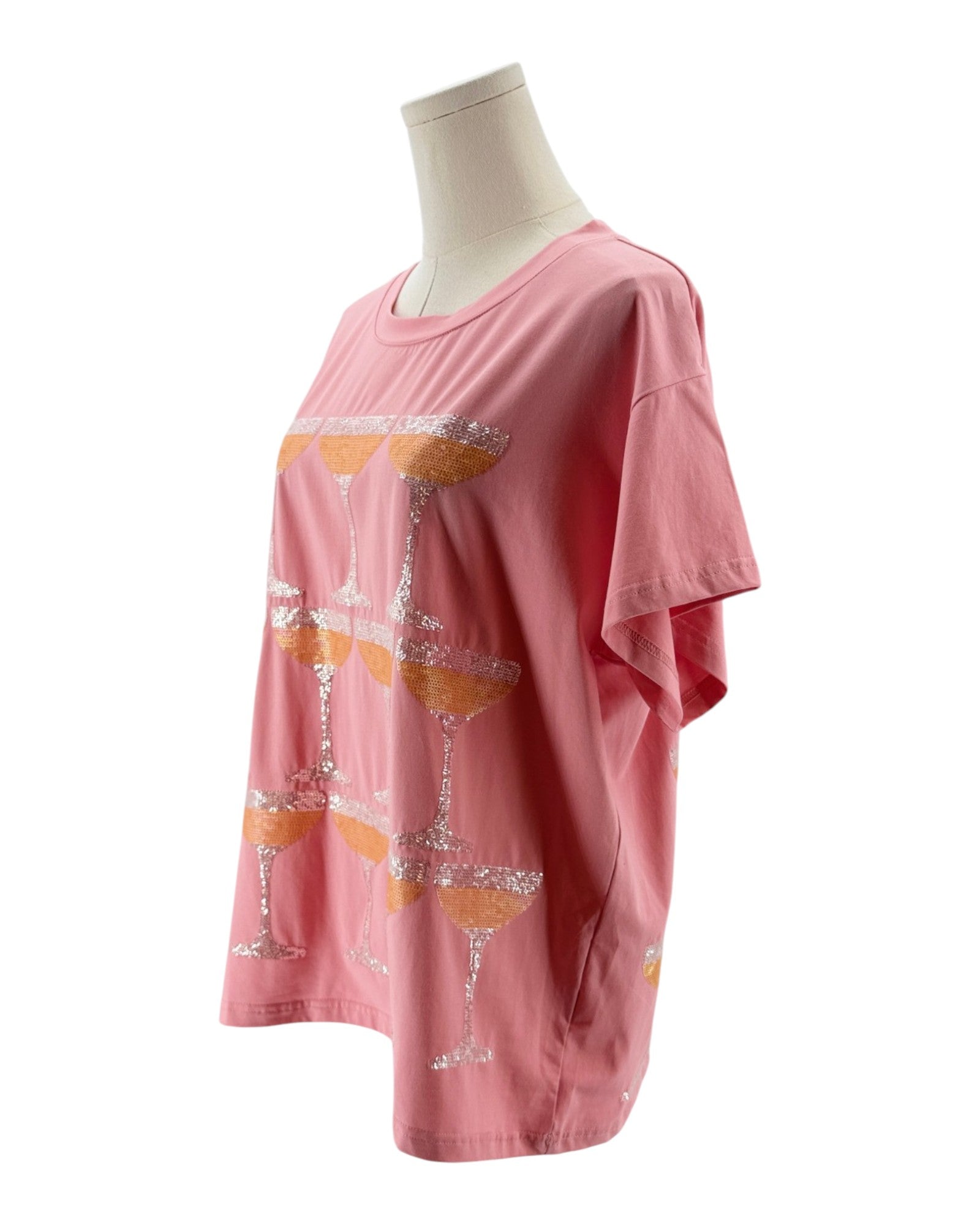 Pink t-shirt with martini glass design on a mannequin against a white background