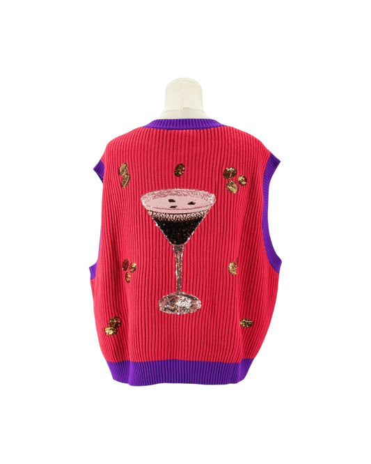 A pink ribbed knit sweater vest with purple trim, featuring a large sequined martini glass graphic on the back and small gold sequin embellishments, displayed on a mannequin torso against a white background.