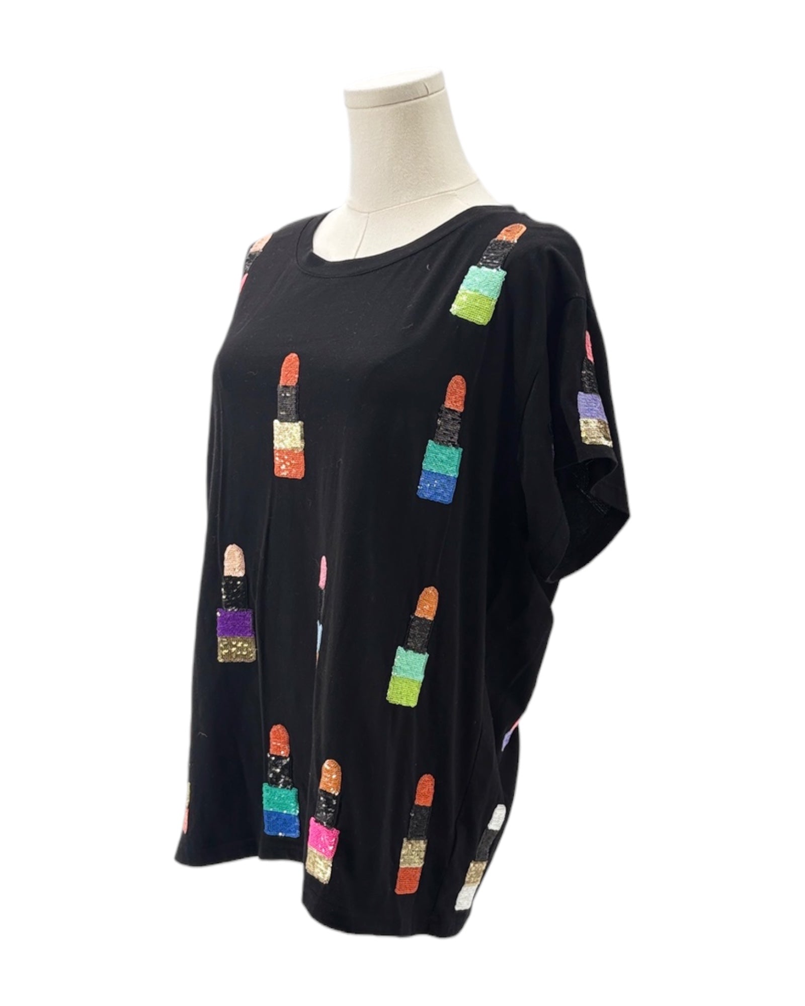 Black top with colorful lip print on a mannequin against a white background
