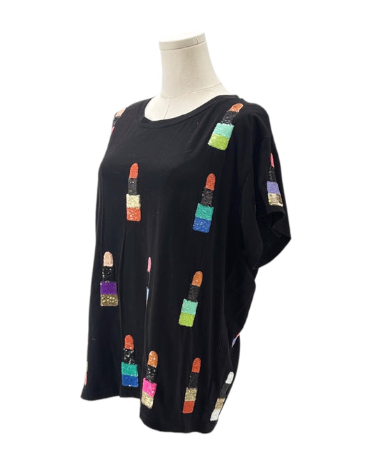 Black top with colorful lip print on a mannequin against a white background