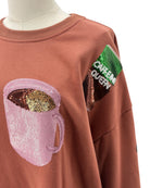 Brown sweatshirt with decorative patches on a mannequin