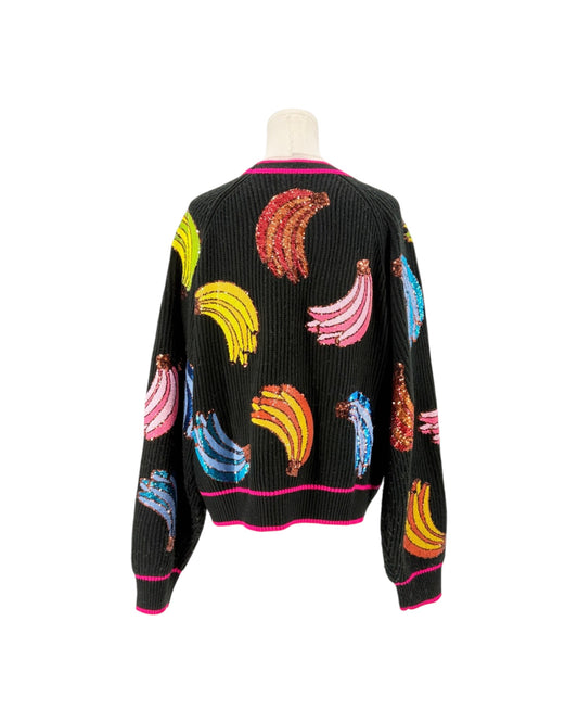 A black ribbed knit cardigan sweater with colorful sequined banana motifs and pink trim, displayed on a white mannequin torso against a white background.