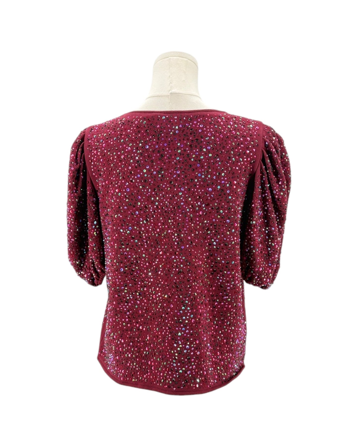 Red sequin top on a mannequin against a white background