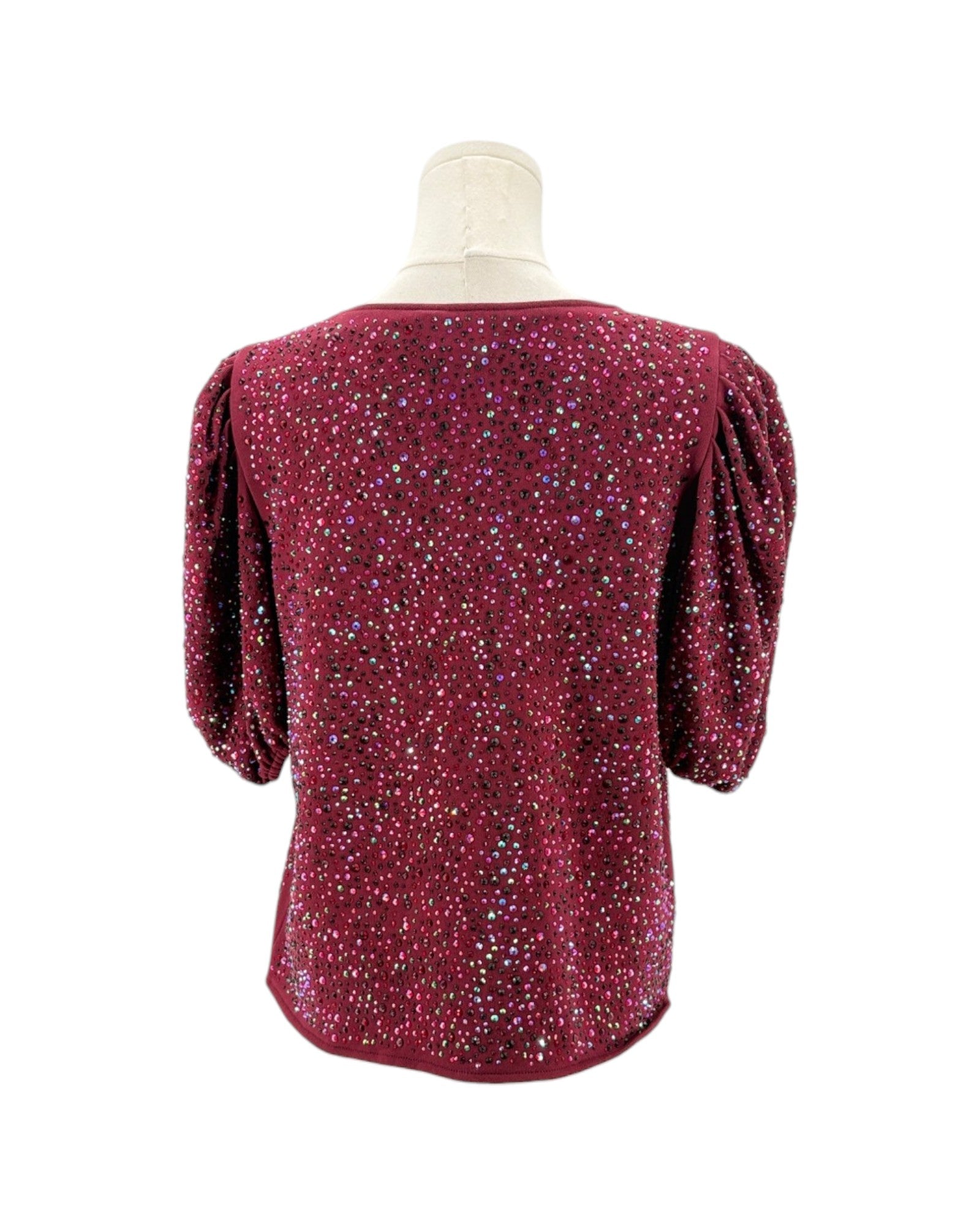 Red sequin top on a mannequin against a white background