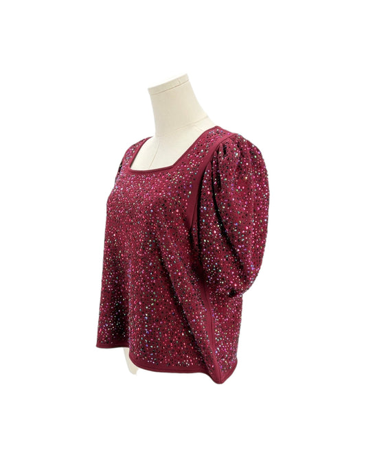 Red blouse with puff sleeves on a mannequin against a white background