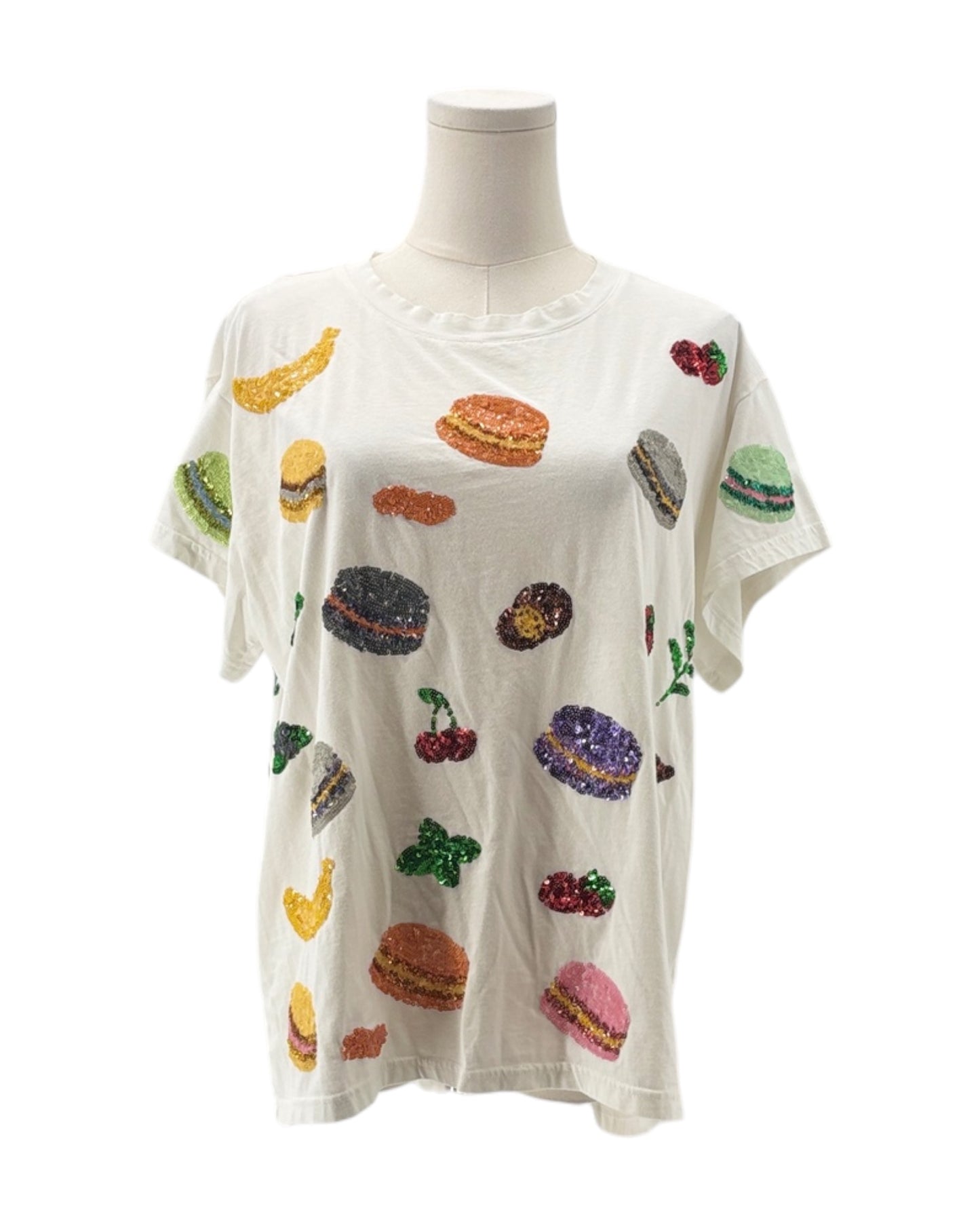 White t-shirt with colorful food graphics on a mannequin against a white background