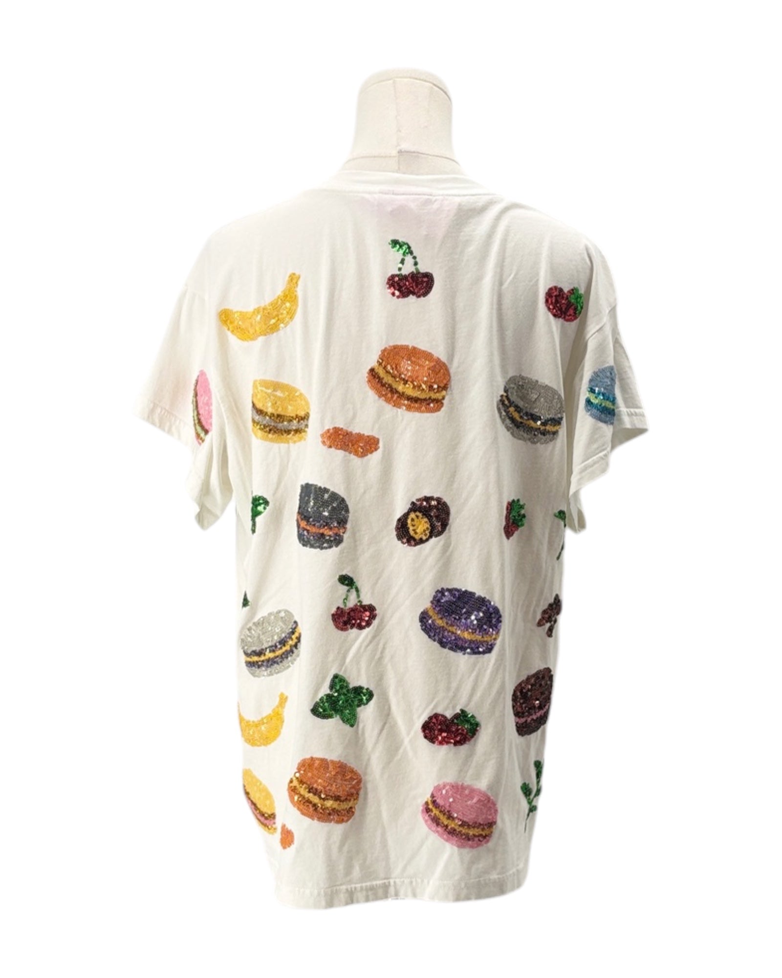 White shirt with colorful food print on a mannequin against a white background