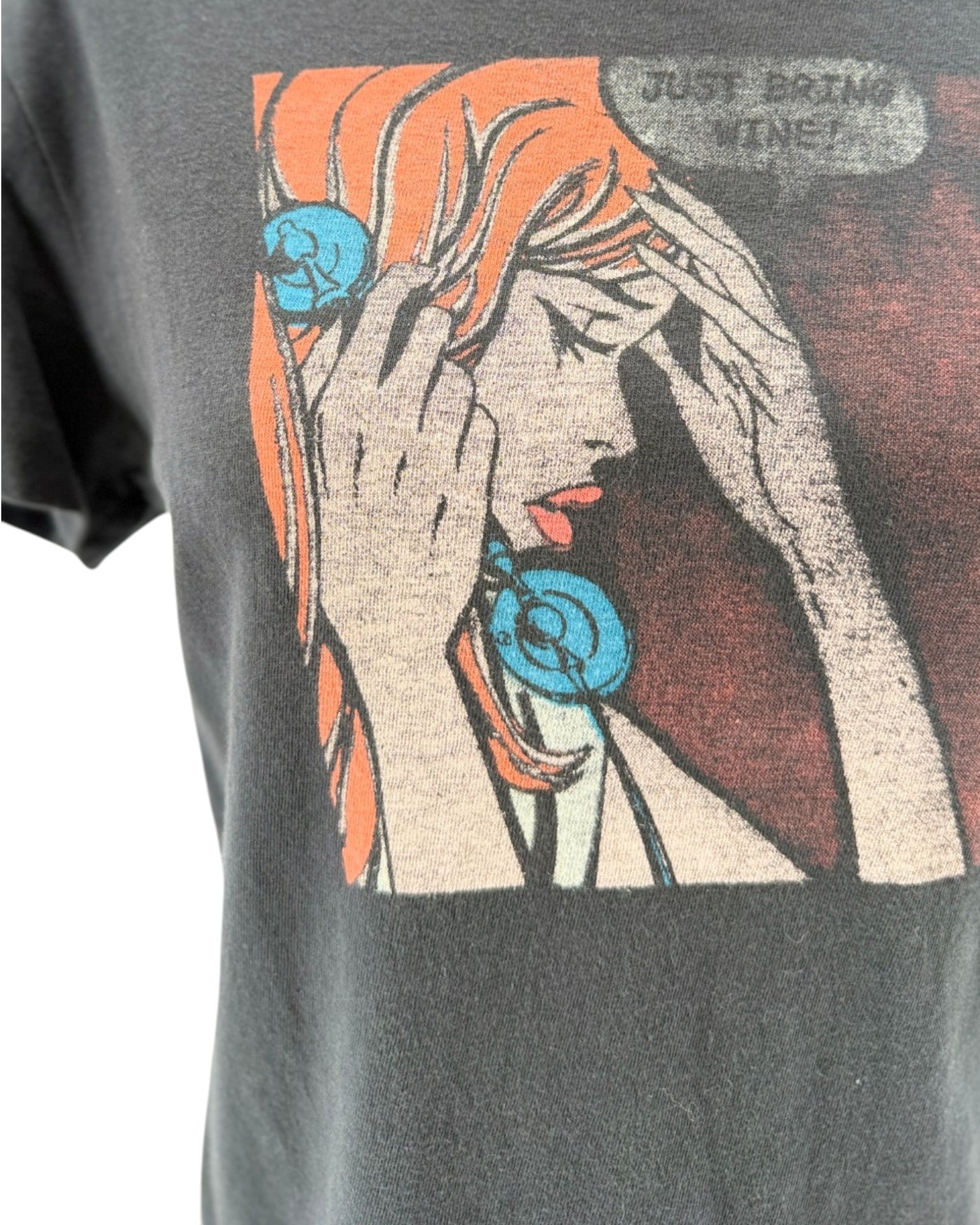 T-shirt with a graphic design of a woman holding her head and text 'Just drink wine!' on a dark gray background.