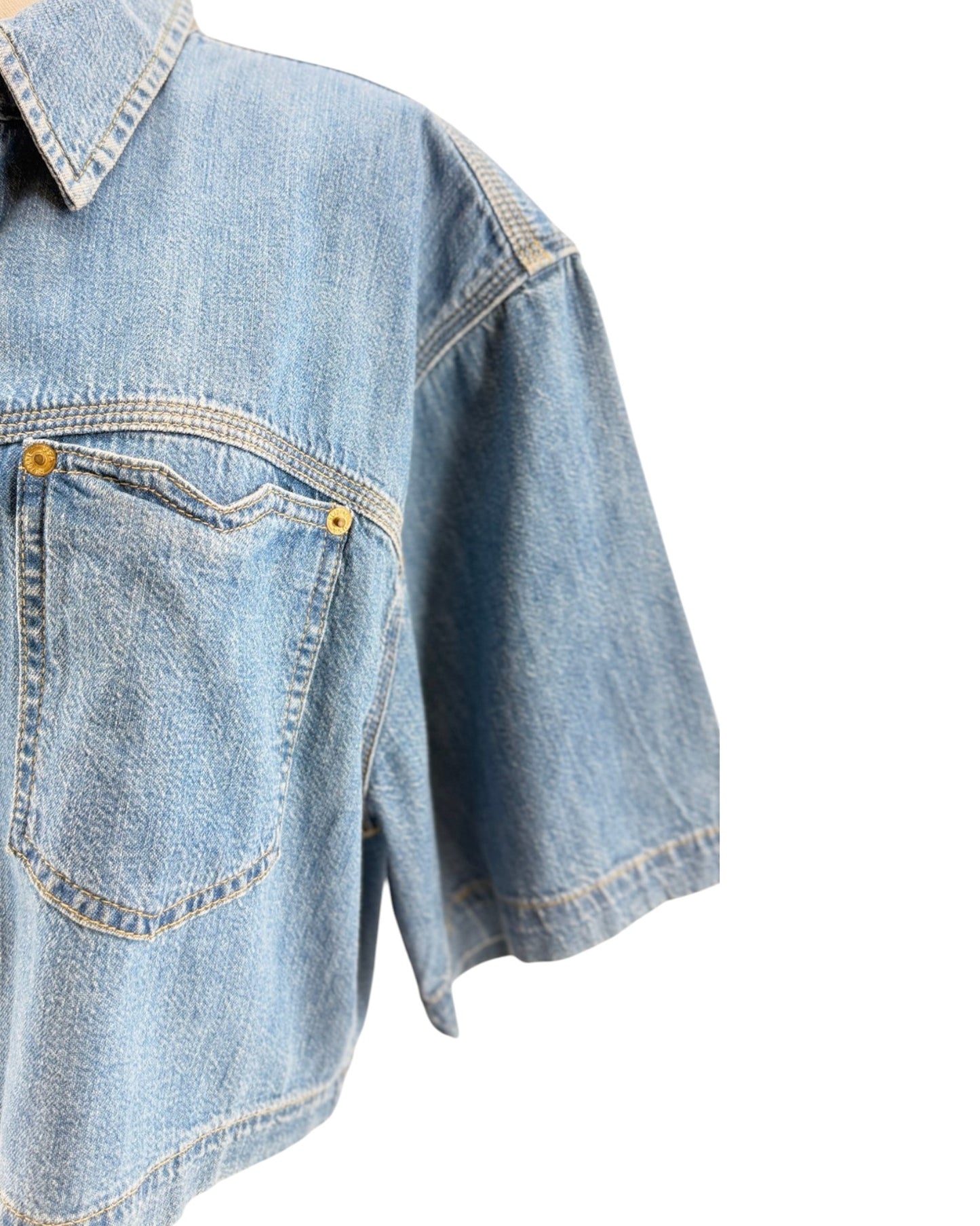 Denim shirt with button details on a white background