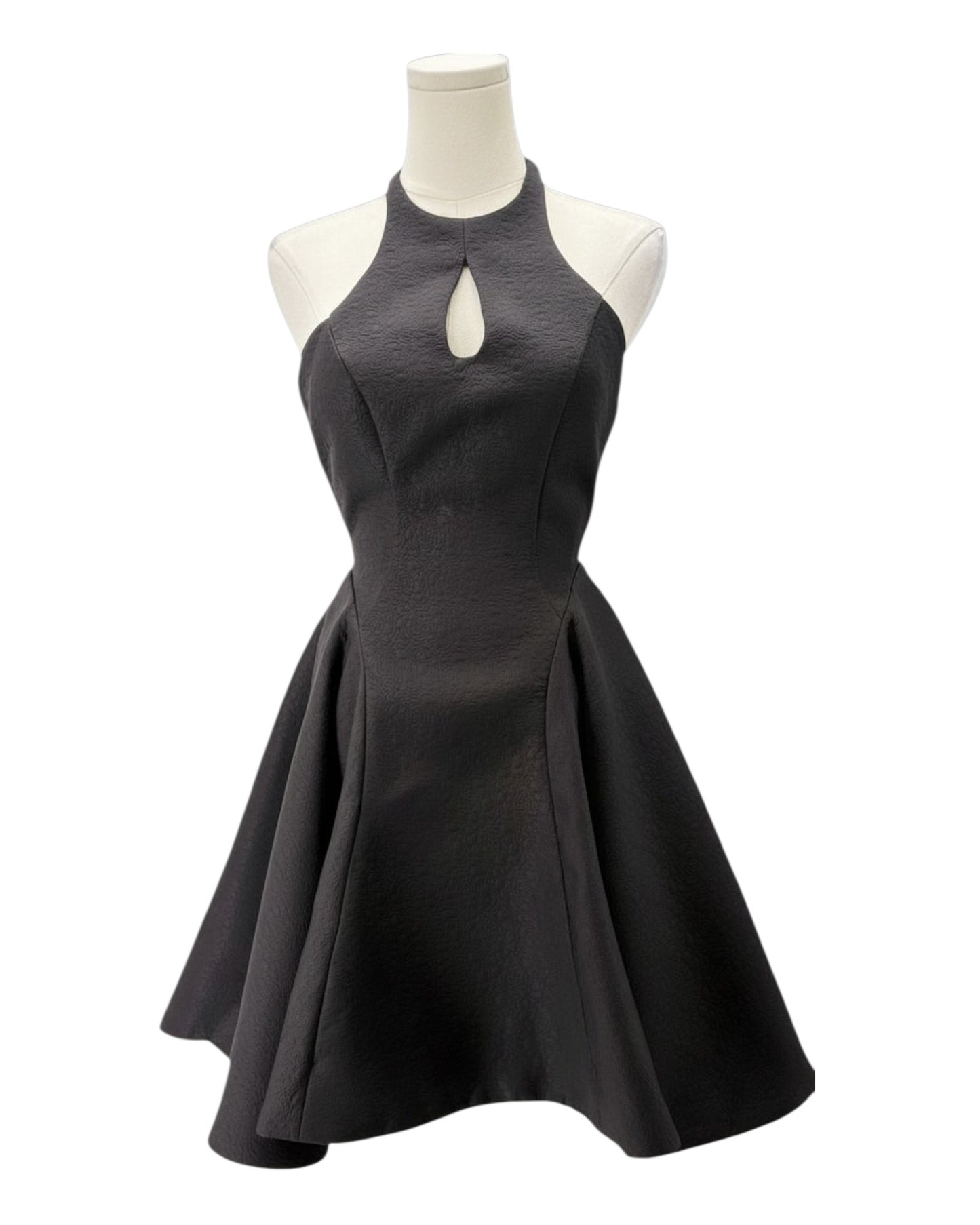 Black dress on a mannequin against a white background