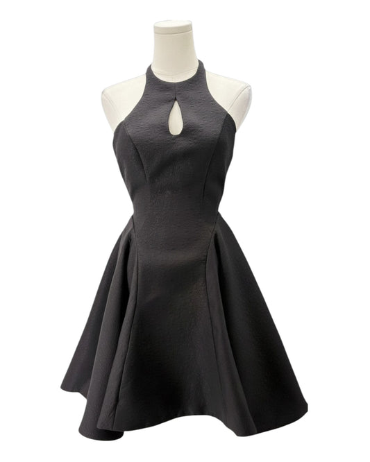 Black dress on a mannequin against a white background