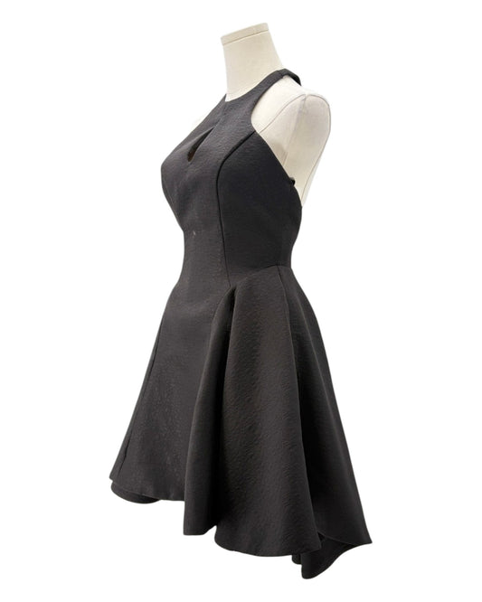 Black dress on a mannequin against a white background