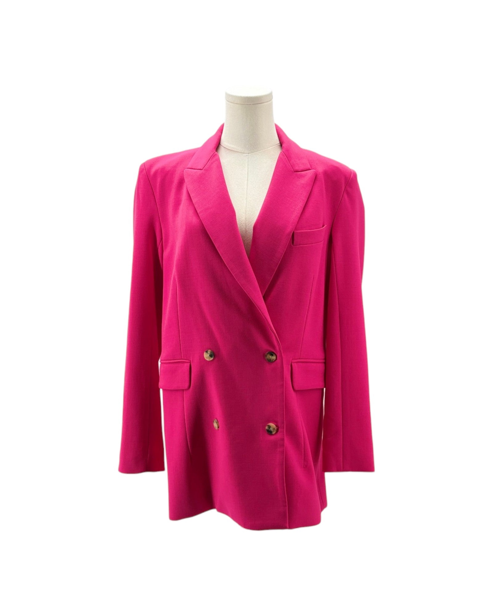 A bright fuchsia pink double-breasted blazer with notched lapels and dark buttons, displayed on a cream mannequin torso against a plain white background.