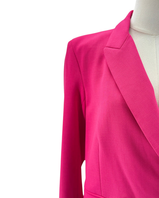 Bright pink tailored blazer shown on a mannequin torso against a plain white background.