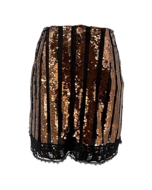 Black and gold sequin shorts on a white background