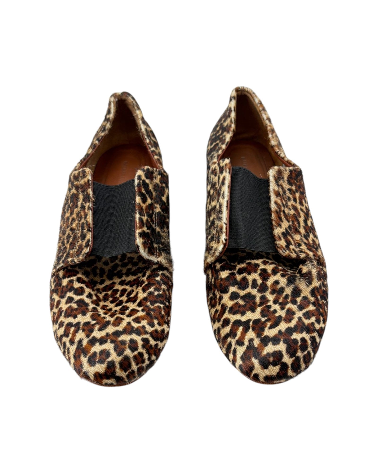 Pair of leopard print loafers on a white background