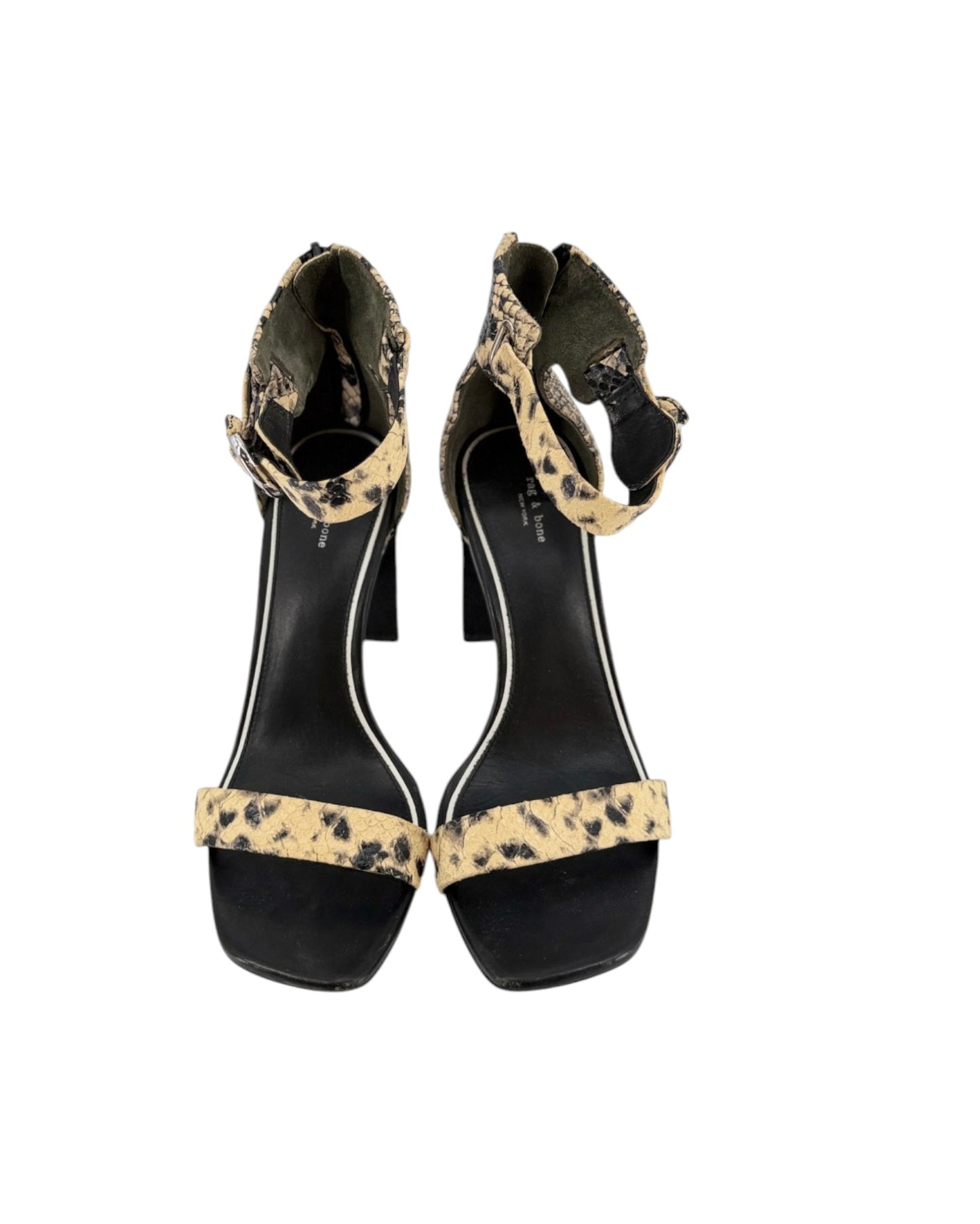 A pair of black block-heel sandals with beige and black leopard-print straps, shown from a top-down view on a white background.