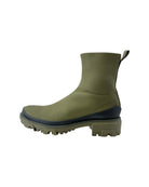 Green rubber boot with a black sole on a white background