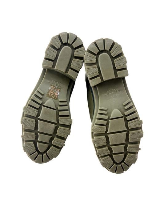 Close-up of a pair of brown boots with tread pattern on a white background