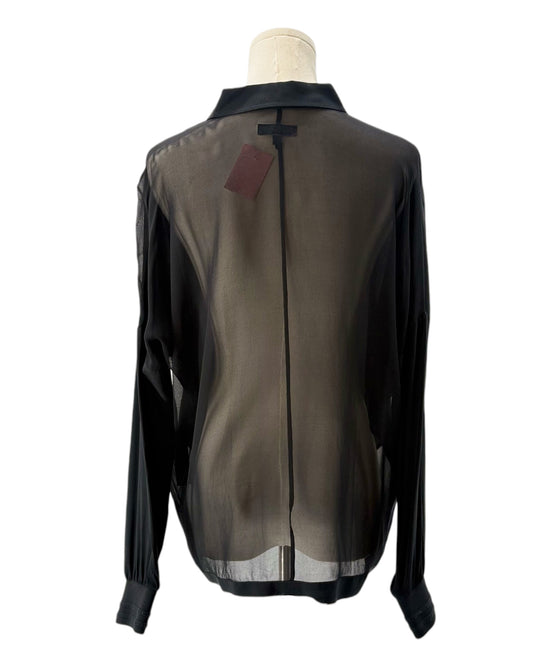 Sheer black blouse on a mannequin with a visible tag against a white background