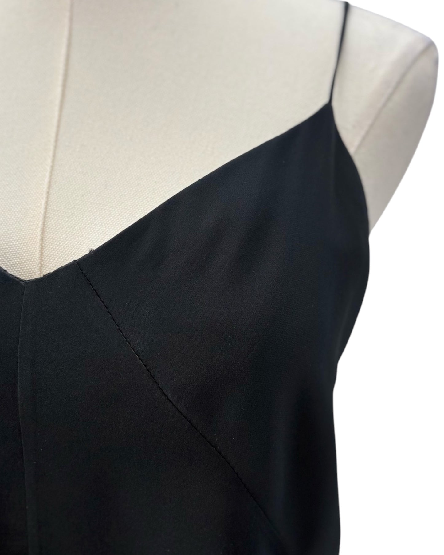 Black camisole top on a mannequin with a white background