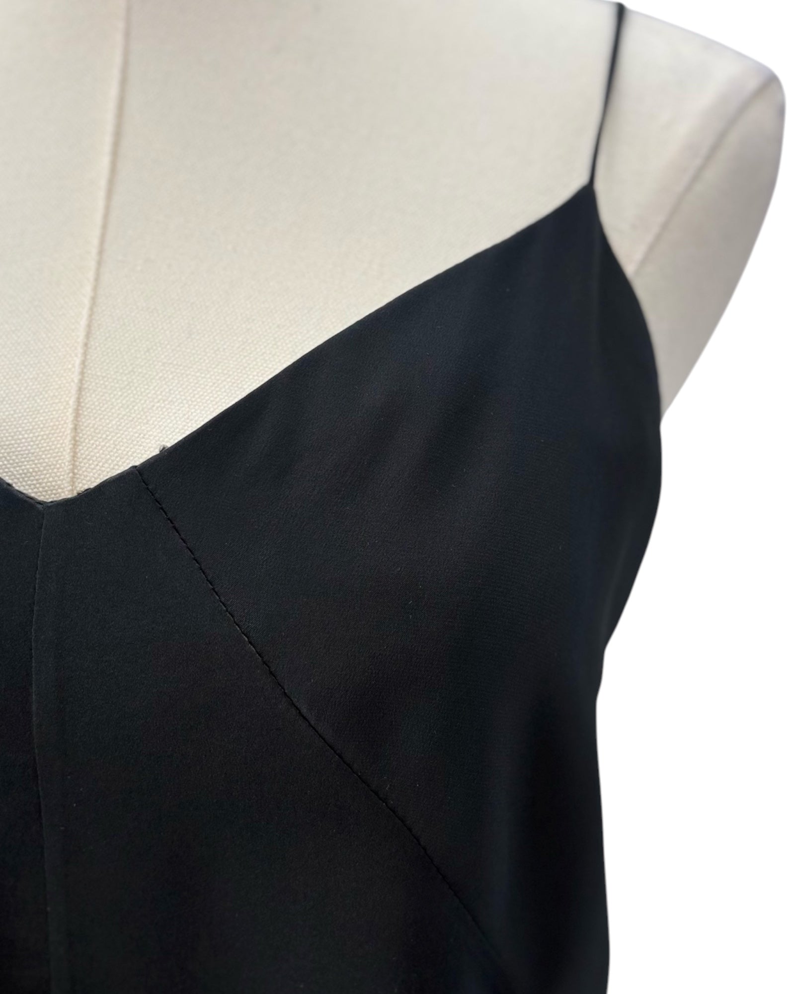 Black camisole top on a mannequin with a white background