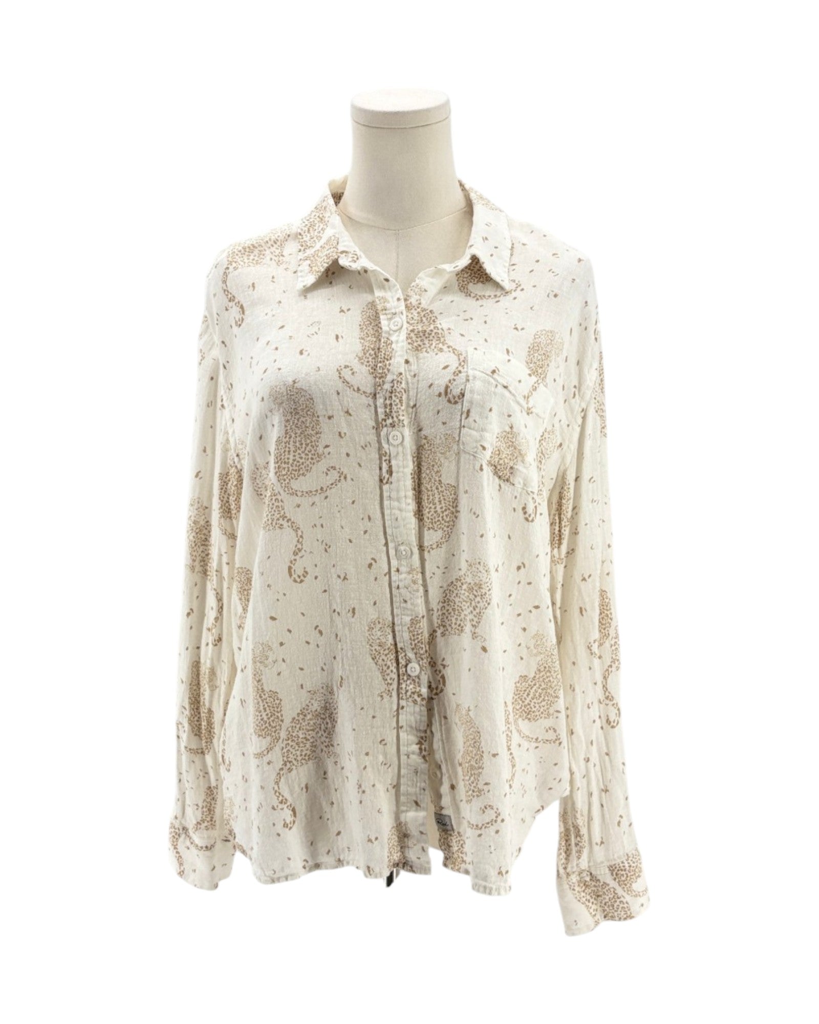 Cream colored long sleeve button down shirt with tan leopards on a mannequin on a white background