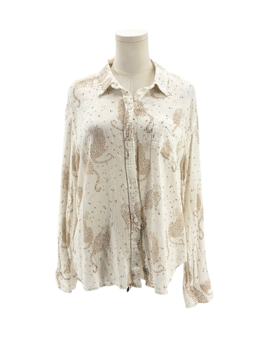 Cream colored long sleeve button down shirt with tan leopards on a mannequin on a white background