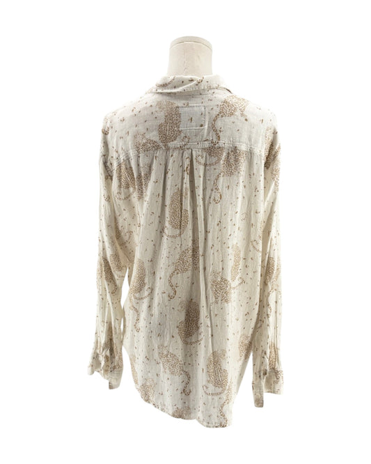 Cream colored long sleeve button down shirt with tan leopards on a mannequin on a white background