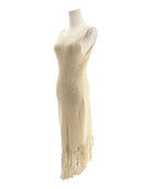 Beige fringe dress on a mannequin against a white background