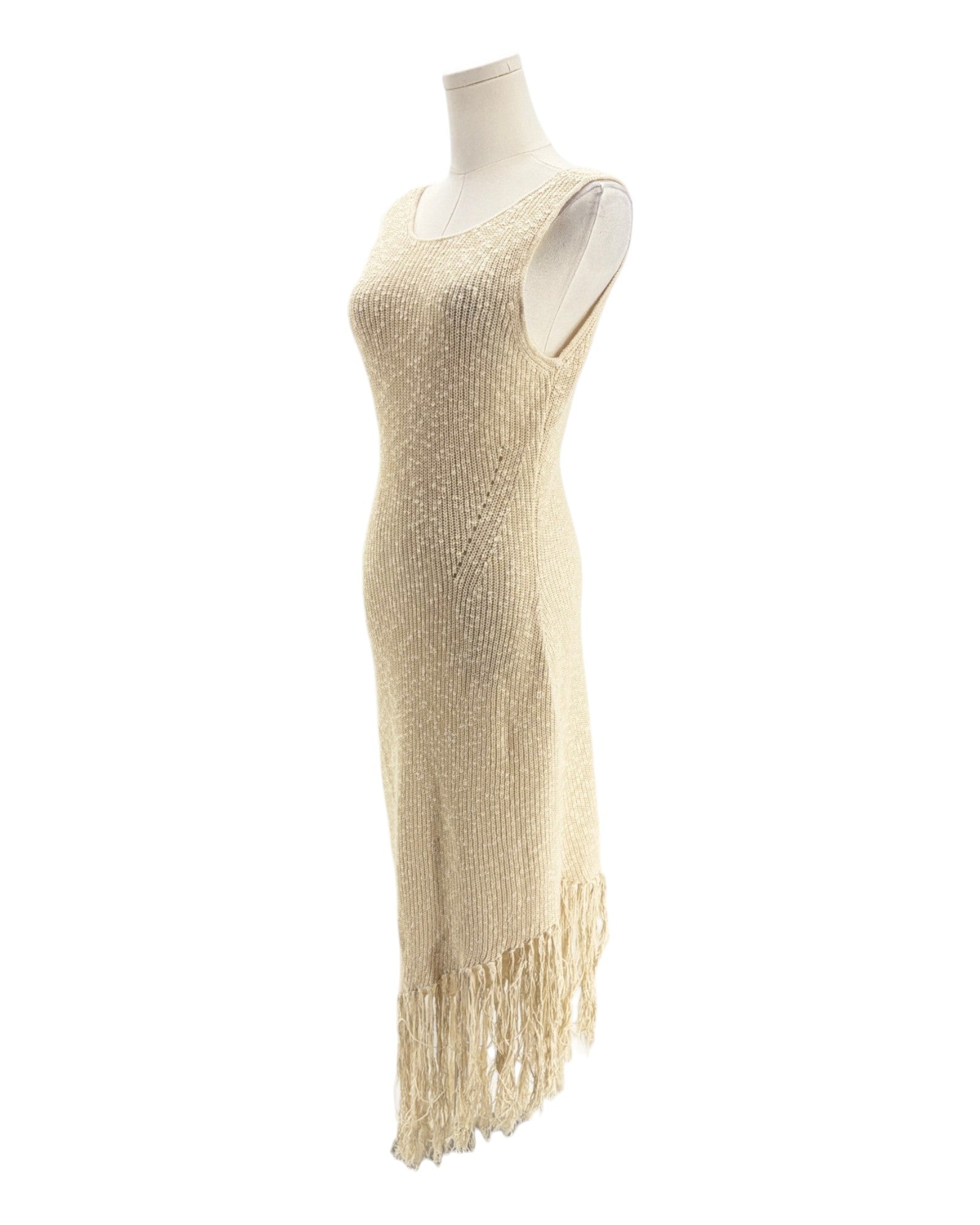 Beige fringe dress on a mannequin against a white background