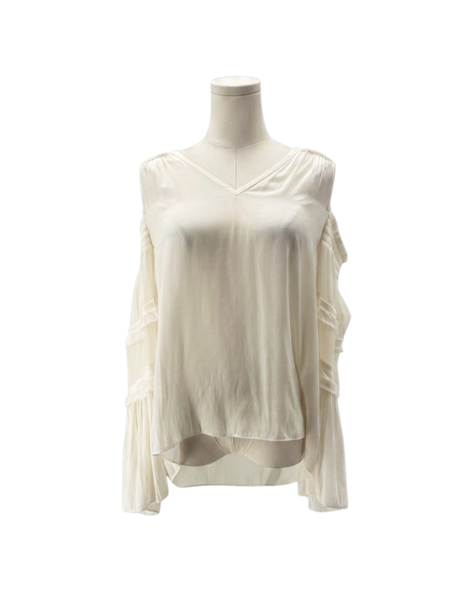 An off-white, long-sleeve blouse with a V-neckline and layered ruffle details on the sleeves, displayed on a mannequin torso against a plain white background.