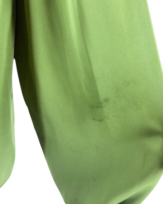 A close-up of olive green fabric with a visible scuff or abrasion on the surface, isolated on a white background.