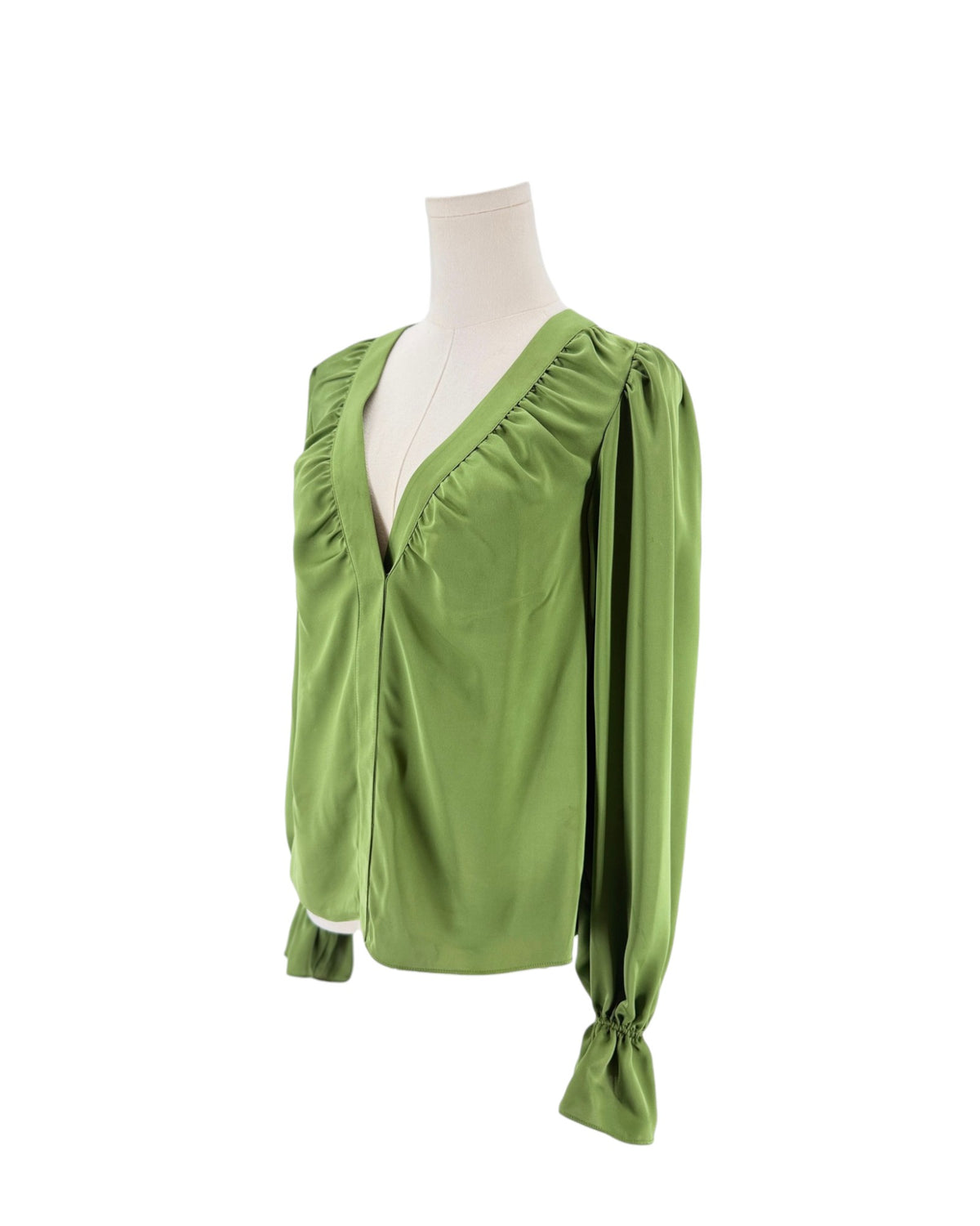 A sage green long-sleeve blouse with a gathered V-neckline and drawstring cuffs, displayed on a cream mannequin torso against a white background.