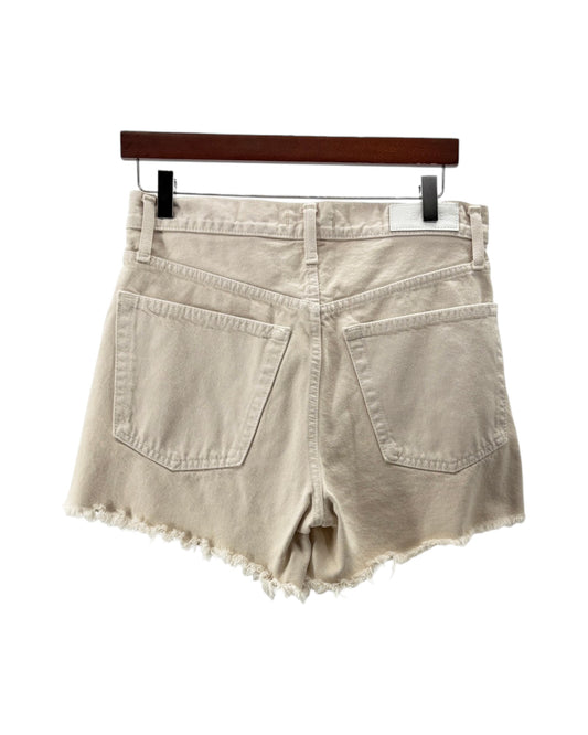 Beige denim shorts on a hanger against a white background