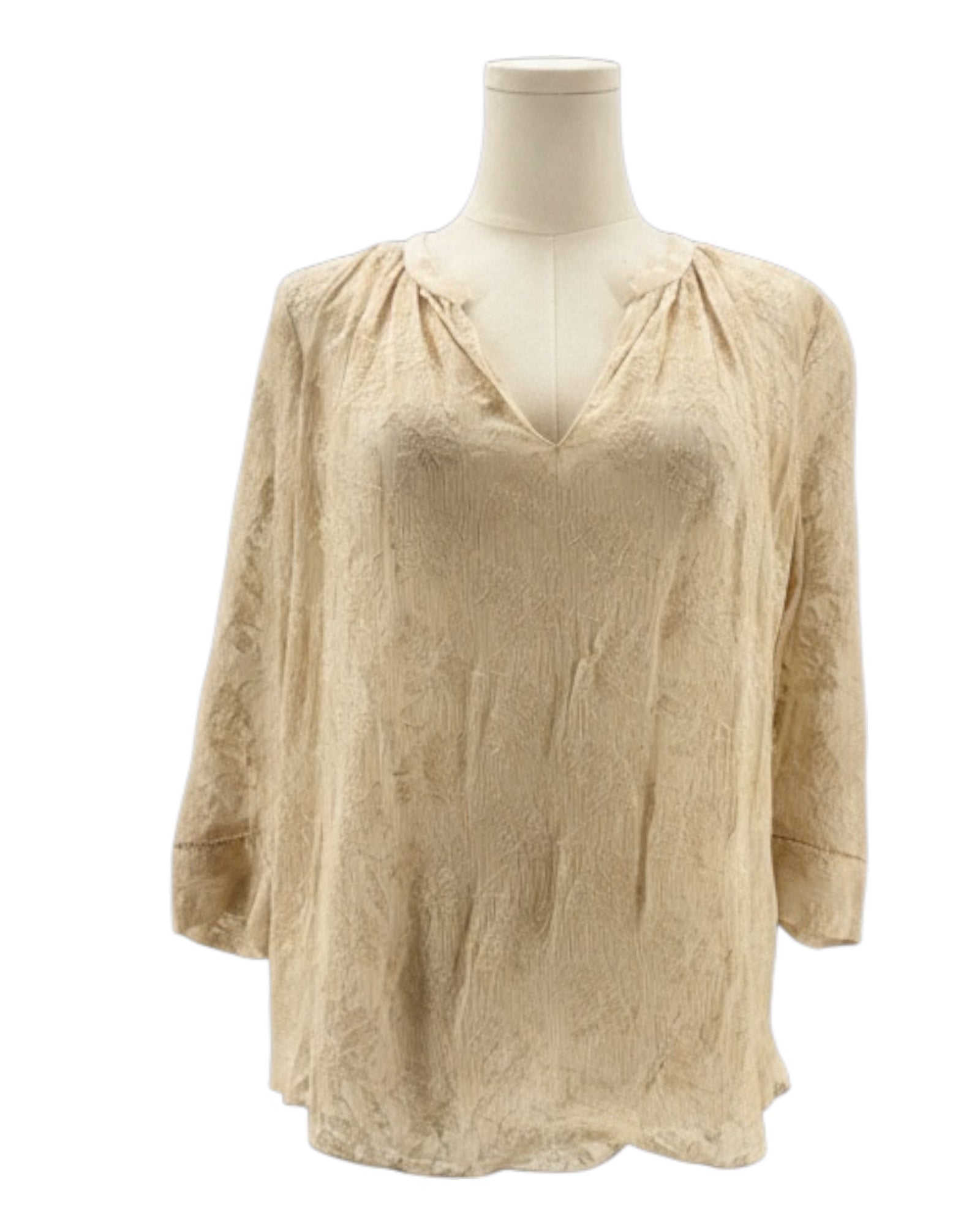 cream blouse with embroidery on a mannequin against a white background