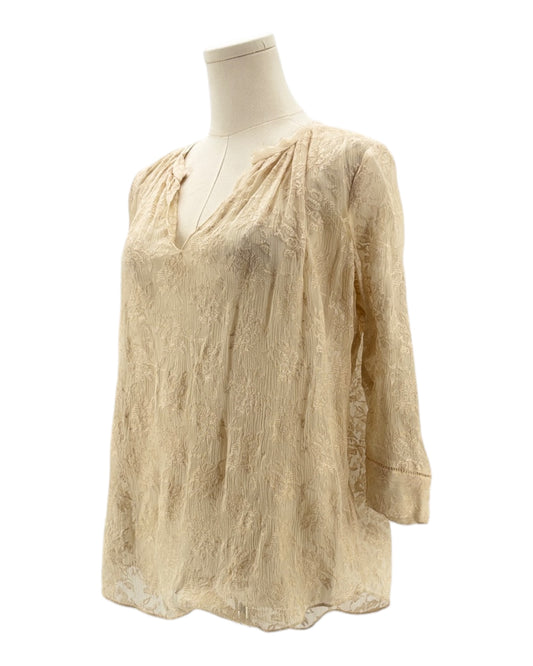 cream blouse with embroidery on a mannequin against a white background
