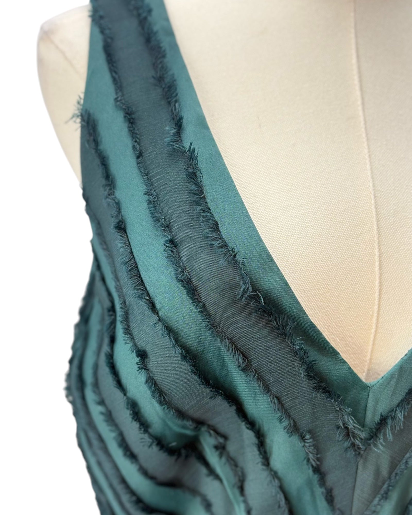 Green dress with frayed edges on a mannequin
